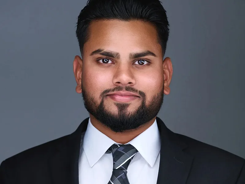 Corporate headshot of a man in a suit and striped tie