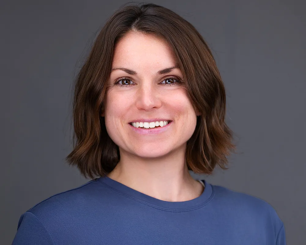 Professional conference headshot of a smiling woman with short brown hair photographed in Orlando.