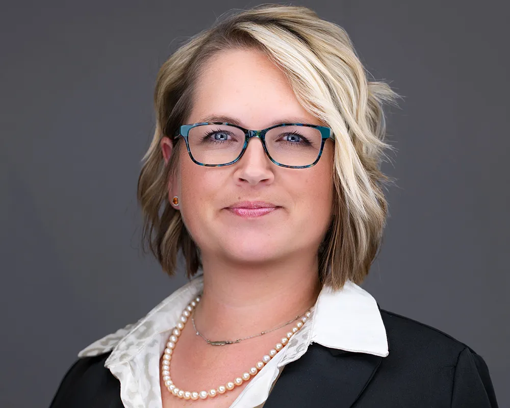 Professional conference headshot of a woman with glasses photographed in Tampa.