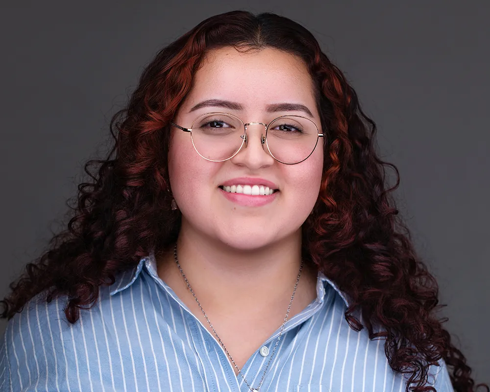Smiling convention attendee photographed at a professional headshot lounge in Orlando.