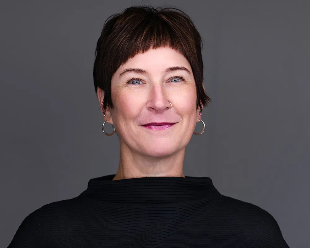 Professional convention headshot of a woman photographed in Tampa against a gray background.