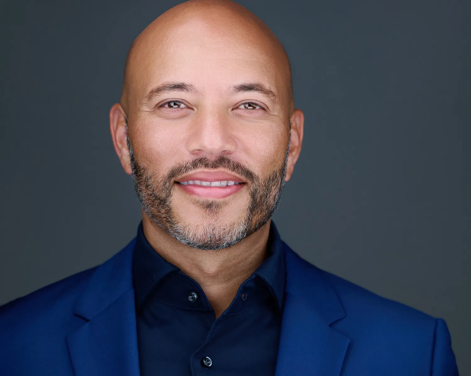 Executive headshot of a smiling man in a blue blazer photographed in Fort Lauderdale.