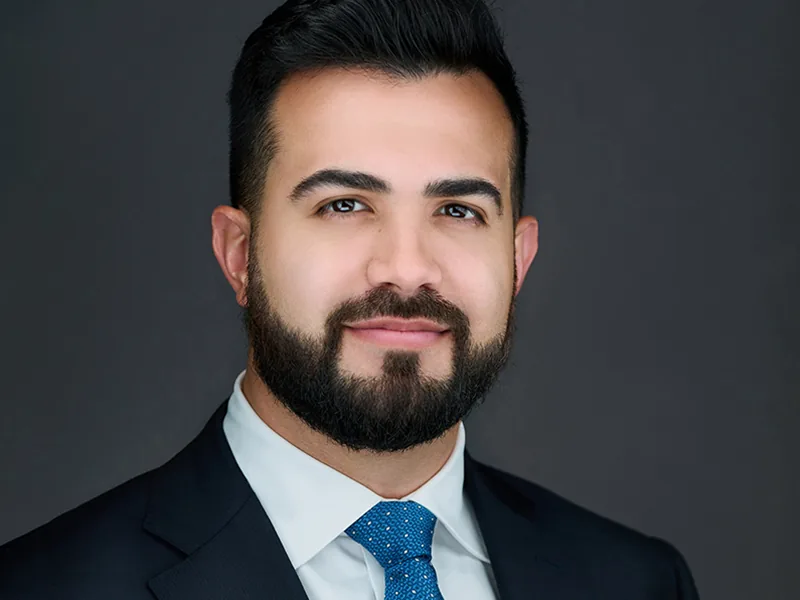 Signature Headshot Session portrait of a man in a navy suit and blue tie