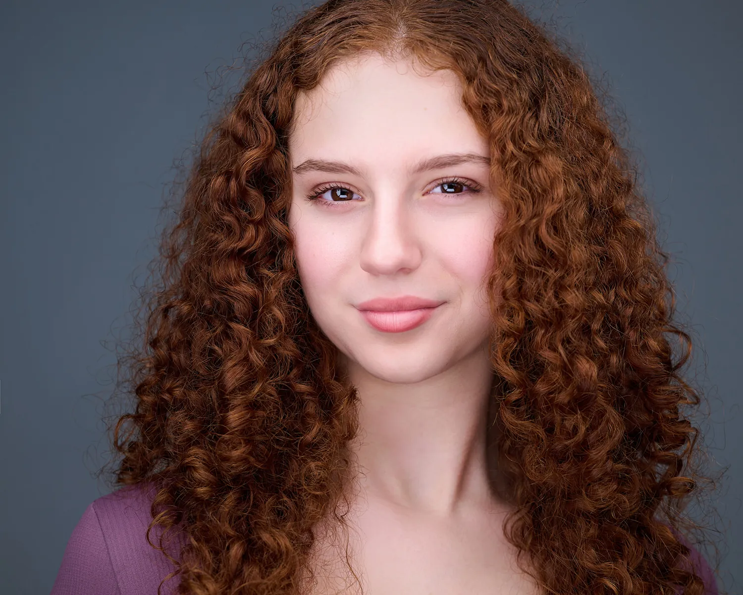 Personal branding headshot of a woman with curly red hair photographed in Fort Lauderdale.