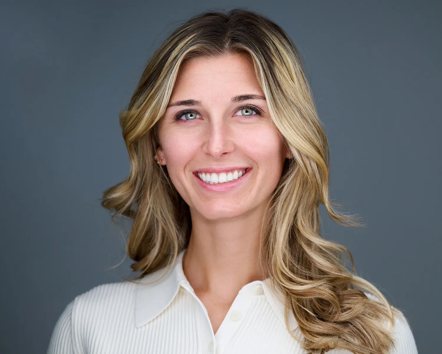 Professional headshot of a smiling blonde woman in a white shirt photographed in Fort Lauderdale.