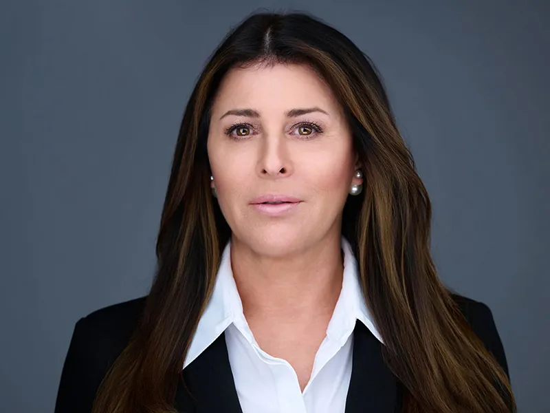 Professional corporate headshot of a Rockefeller Capital executive wearing a black blazer.