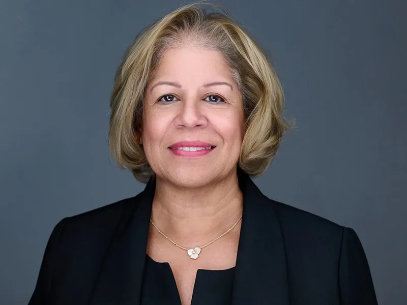 Professional corporate headshot of a Rockefeller executive in business attire.
