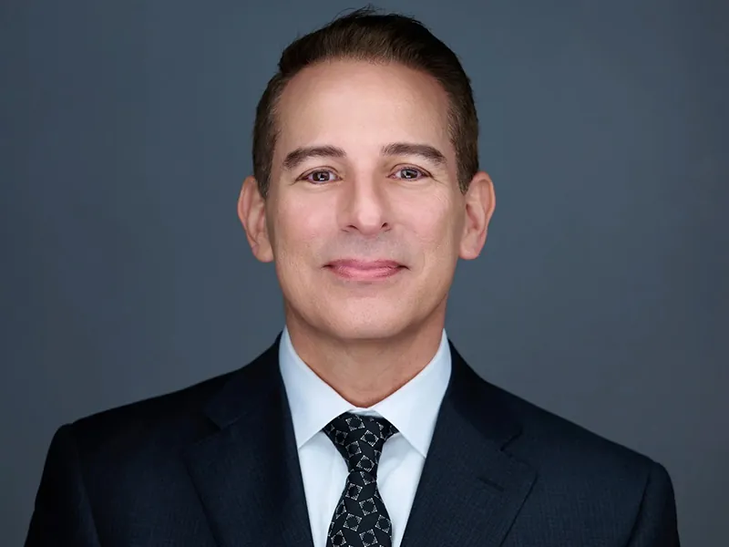 Professional team headshot of a Rockefeller executive in a suit and tie.
